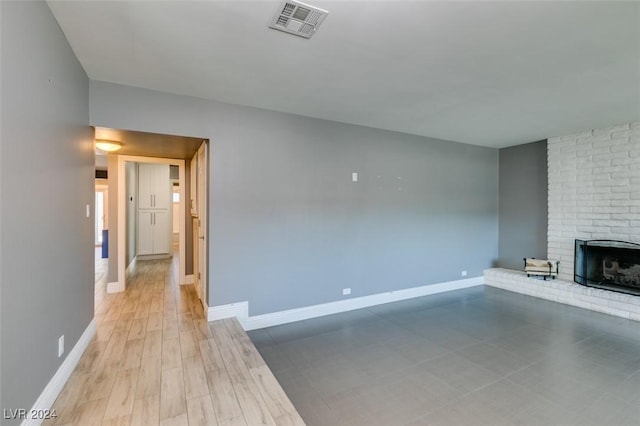 unfurnished living room with a brick fireplace