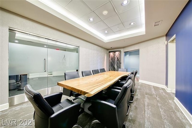 dining area with a raised ceiling