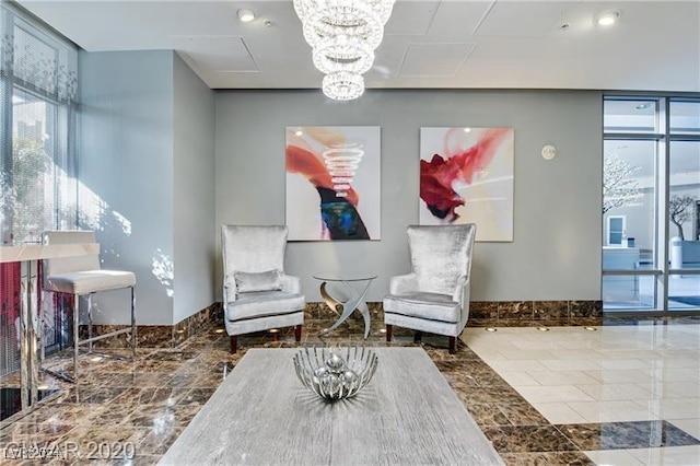 sitting room with an inviting chandelier and a wall of windows