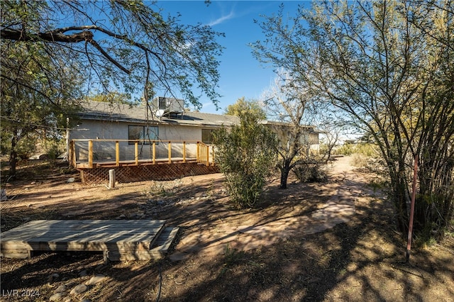 back of house featuring a wooden deck