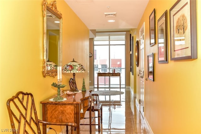 hall with tile patterned flooring and plenty of natural light