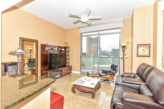 living room with light tile patterned flooring and a ceiling fan