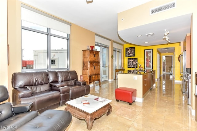 living room featuring sink and light tile patterned floors