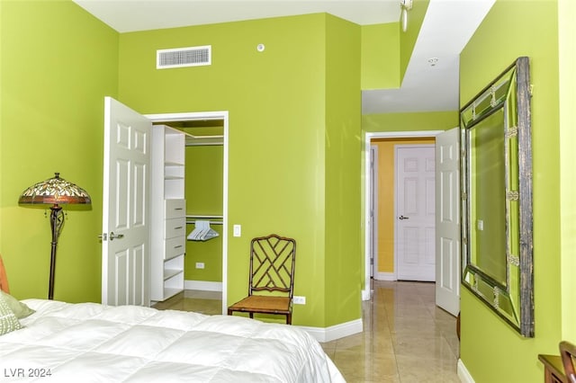 bedroom featuring light tile patterned floors and a closet