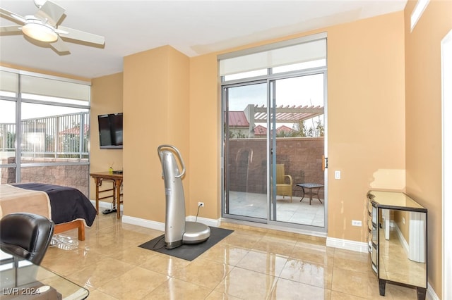 interior space with light tile patterned floors, baseboards, and a ceiling fan