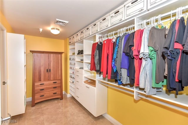 spacious closet with light tile patterned floors