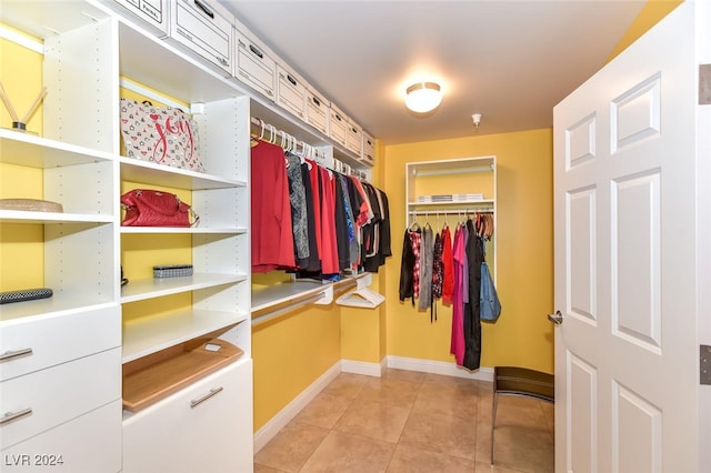 spacious closet with light tile patterned floors