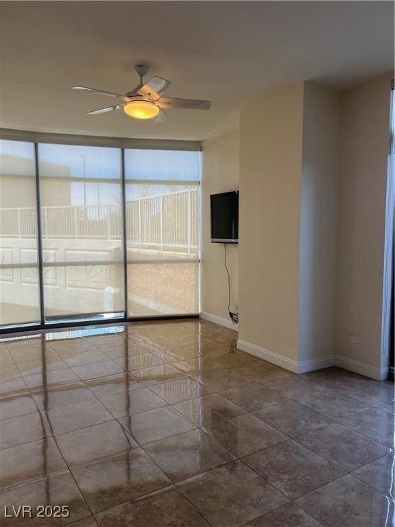 unfurnished room featuring tile patterned floors, baseboards, and a ceiling fan