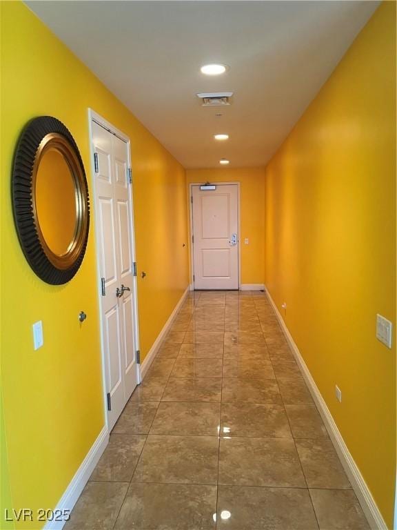 hallway featuring baseboards, recessed lighting, tile patterned flooring, and visible vents