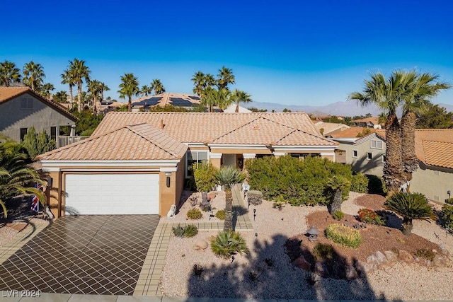 view of front of property with a mountain view and a garage