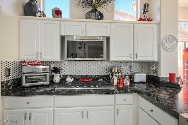 kitchen featuring a wealth of natural light, white cabinetry, and gas stovetop