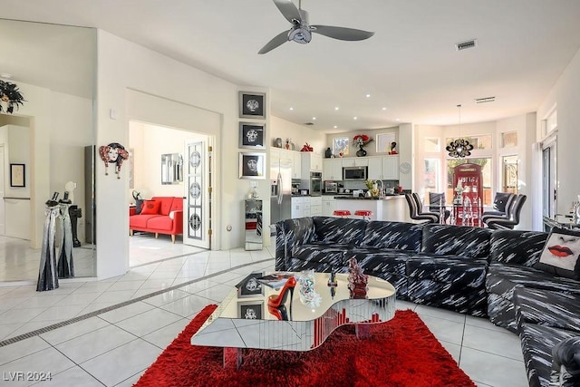 living room featuring ceiling fan and light tile patterned floors