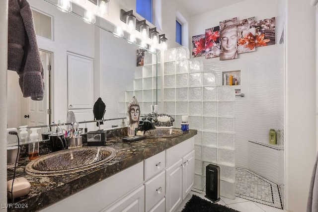 bathroom with tile patterned floors, vanity, and tile walls