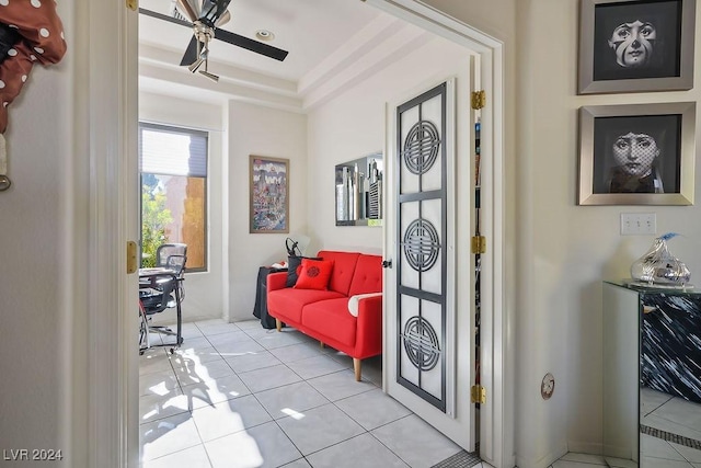 sitting room with ceiling fan and light tile patterned flooring