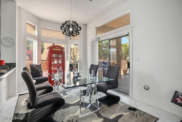 tiled dining area featuring a chandelier