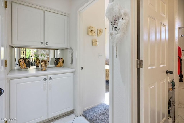 interior space featuring white cabinets and light tile patterned floors