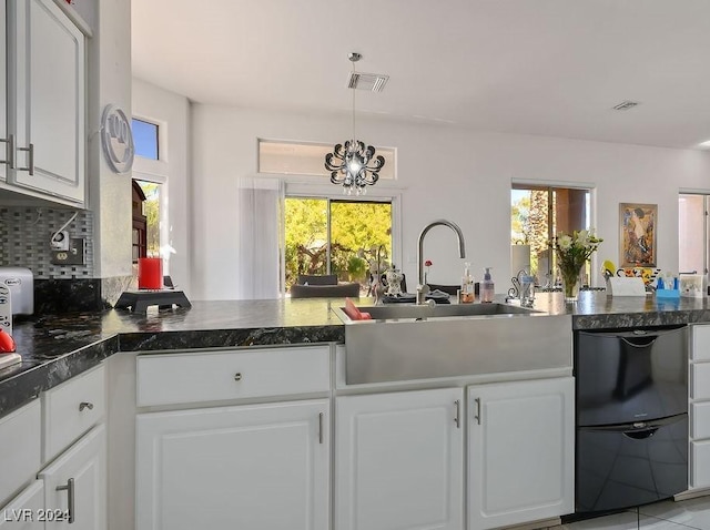 kitchen with white cabinetry, sink, and a notable chandelier