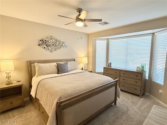 bedroom featuring ceiling fan and light carpet