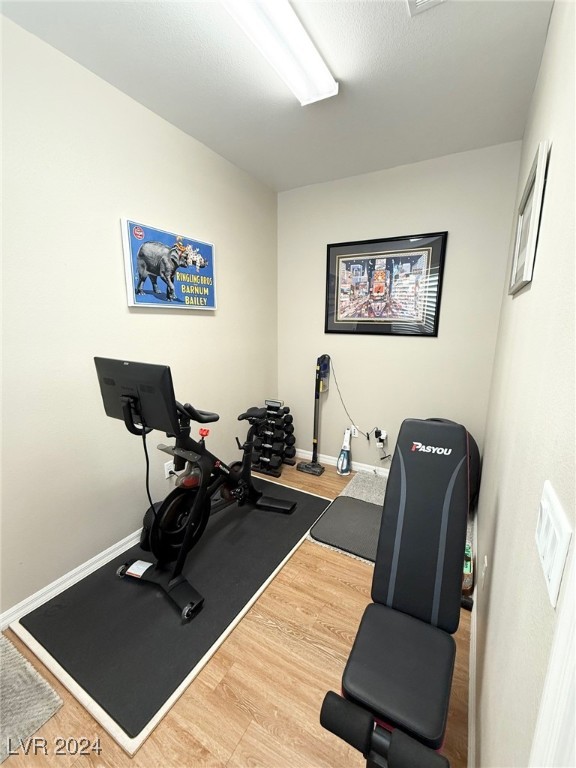 exercise area featuring hardwood / wood-style floors