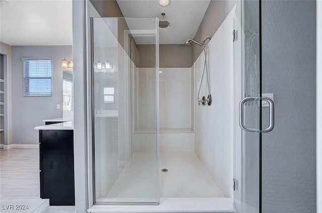 bathroom with vanity and a shower with shower door