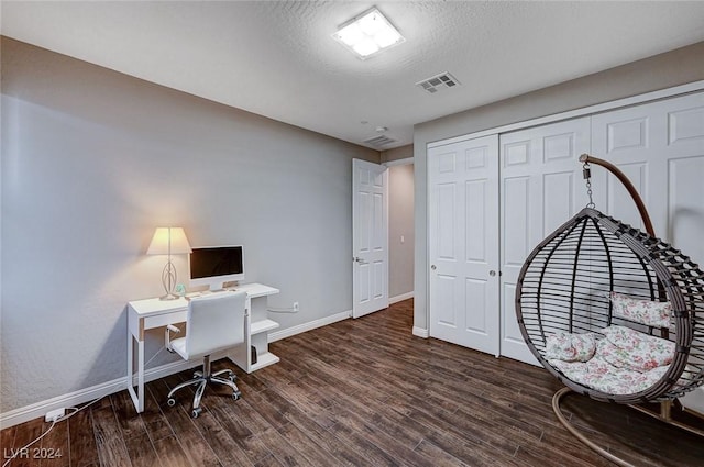 office with dark hardwood / wood-style floors and a textured ceiling