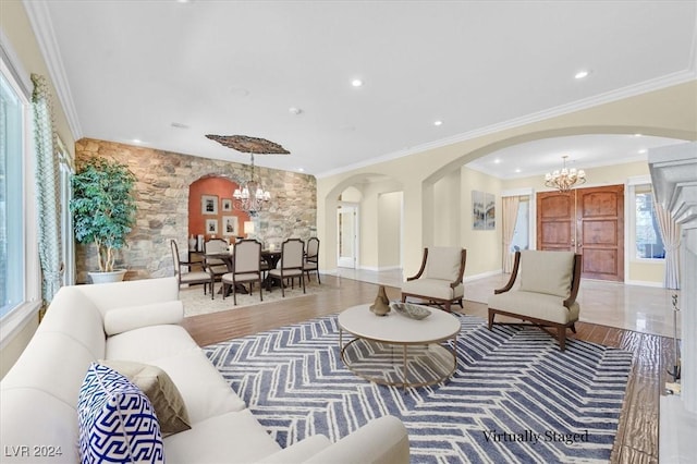 living room featuring crown molding and a notable chandelier