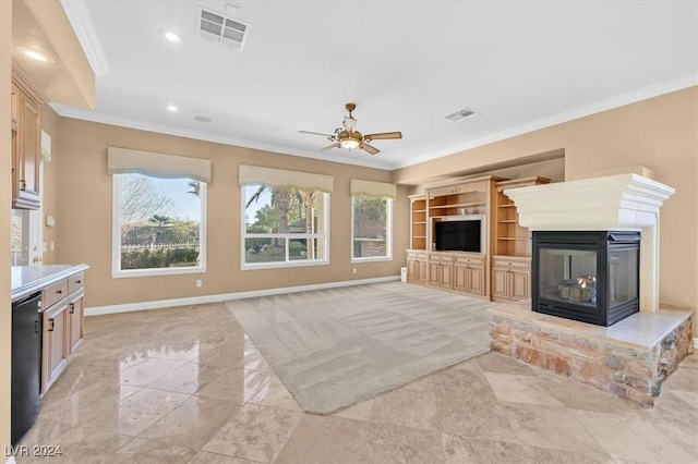 unfurnished living room featuring ceiling fan, a multi sided fireplace, crown molding, and built in shelves