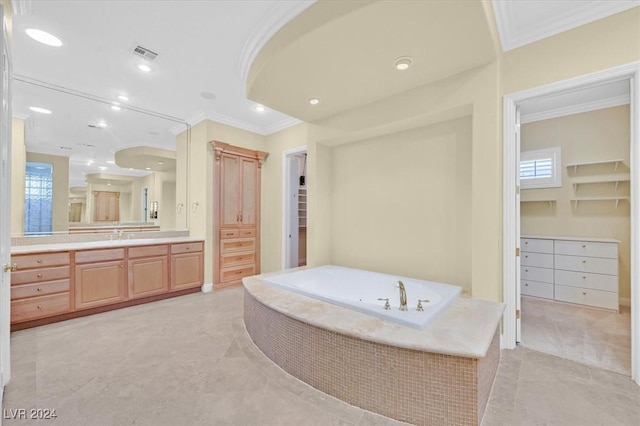 bathroom featuring vanity, tile patterned floors, crown molding, and tiled tub