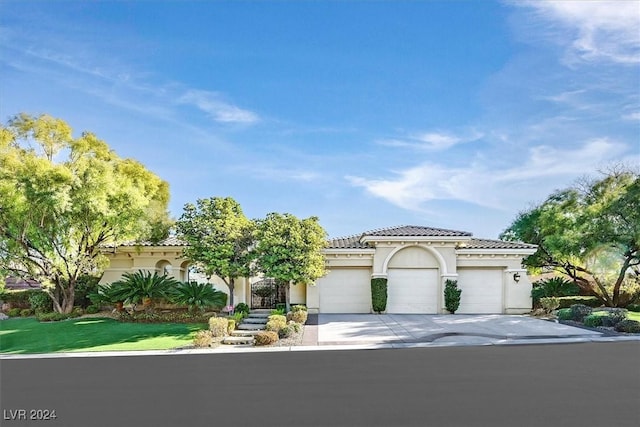 mediterranean / spanish house with a garage