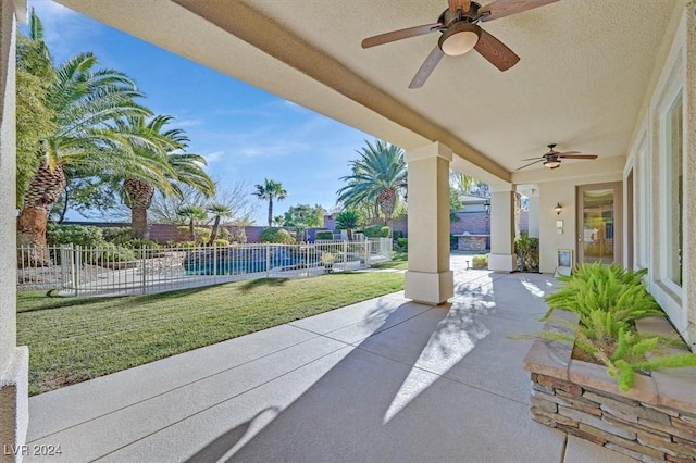 view of patio / terrace with ceiling fan and a fenced in pool