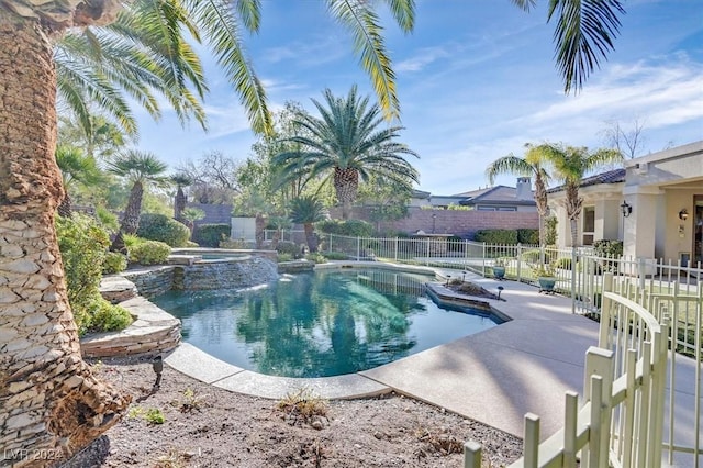 view of swimming pool featuring an in ground hot tub and a patio