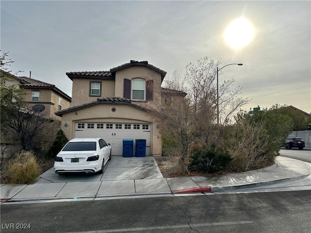 mediterranean / spanish home with a garage