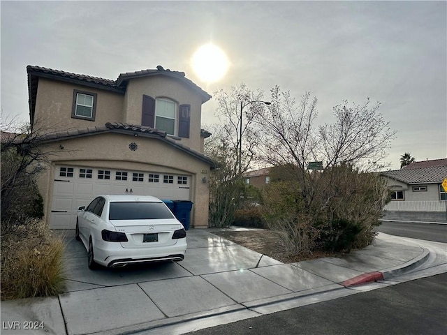 mediterranean / spanish-style house with a garage