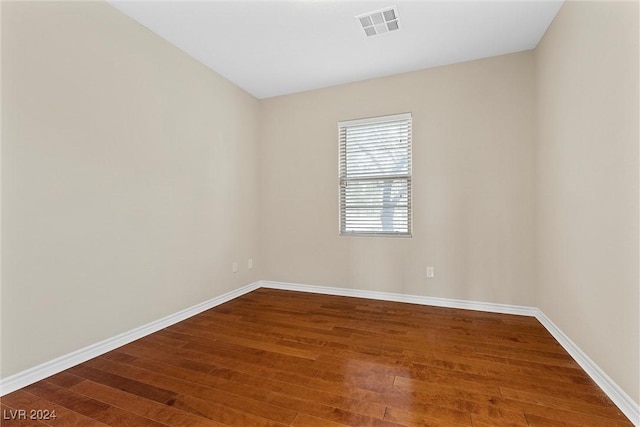 unfurnished room with hardwood / wood-style floors