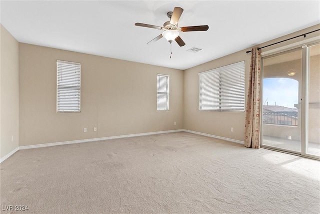 empty room with light colored carpet and ceiling fan