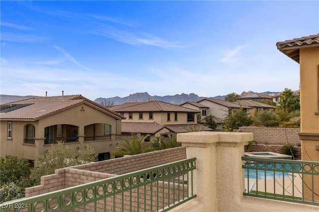 exterior space with an in ground hot tub and a mountain view