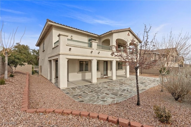 back of house with a patio and a balcony