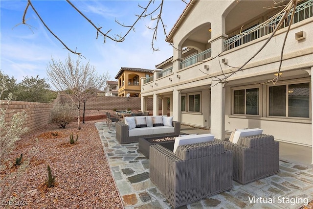 view of patio with a balcony and outdoor lounge area