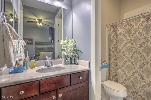 bathroom with vanity, toilet, and ceiling fan