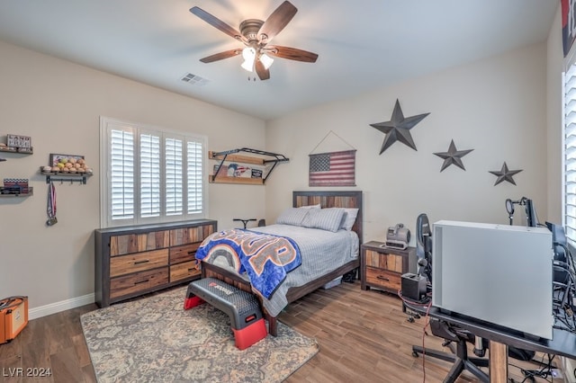 bedroom with hardwood / wood-style floors and ceiling fan