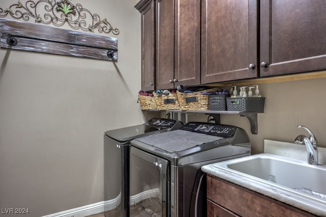 laundry room with washing machine and dryer, sink, and cabinets