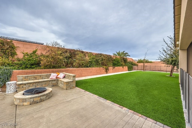 view of yard with a fire pit and a patio area