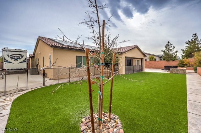 view of yard featuring a patio and central AC