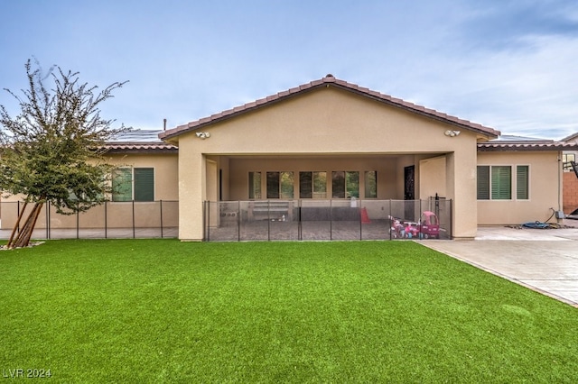 rear view of house with a patio area and a yard