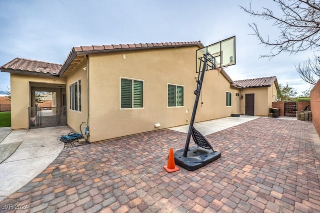 8351 Agave Bloom St, Las Vegas, NV 89131 - back of house with stucco siding, a gate, a tile roof, and a patio