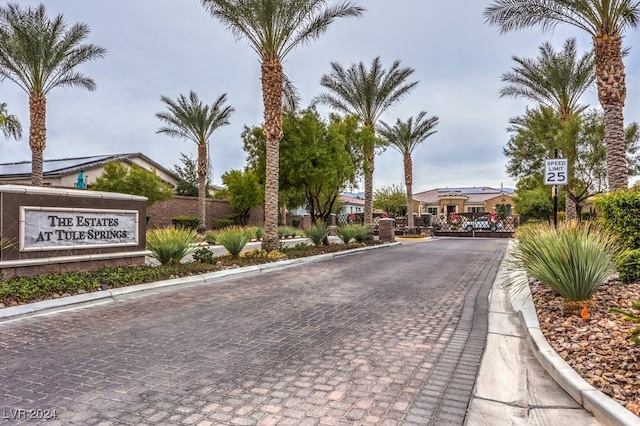 8351 Agave Bloom St, Las Vegas, NV 89131 - view of road featuring traffic signs, curbs, and a gated entry
