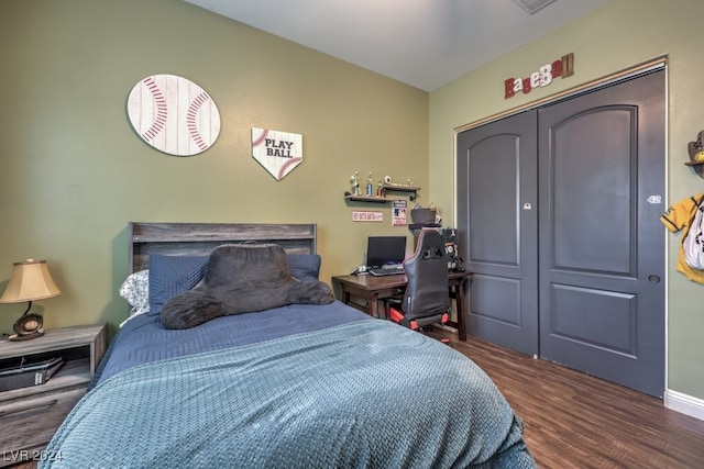 bedroom with a closet and dark wood-type flooring