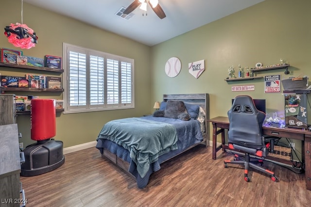 bedroom with dark hardwood / wood-style flooring and ceiling fan