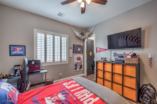 bedroom with hardwood / wood-style floors and ceiling fan