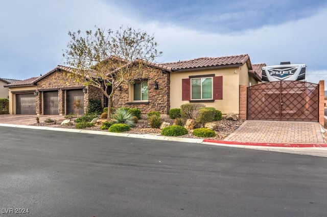 mediterranean / spanish-style home with a garage and central air condition unit